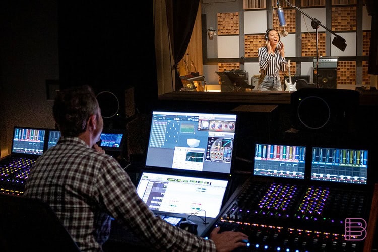 Recording engineer mixing a vocal session in a studio