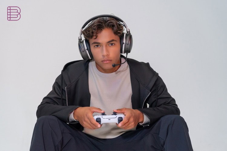 Gamer wearing the Audeze Maxwell 2 ANC headset with controller