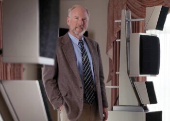 Dave Wilson, founder of Wilson Audio Specialties, standing beside the WAMM loudspeaker