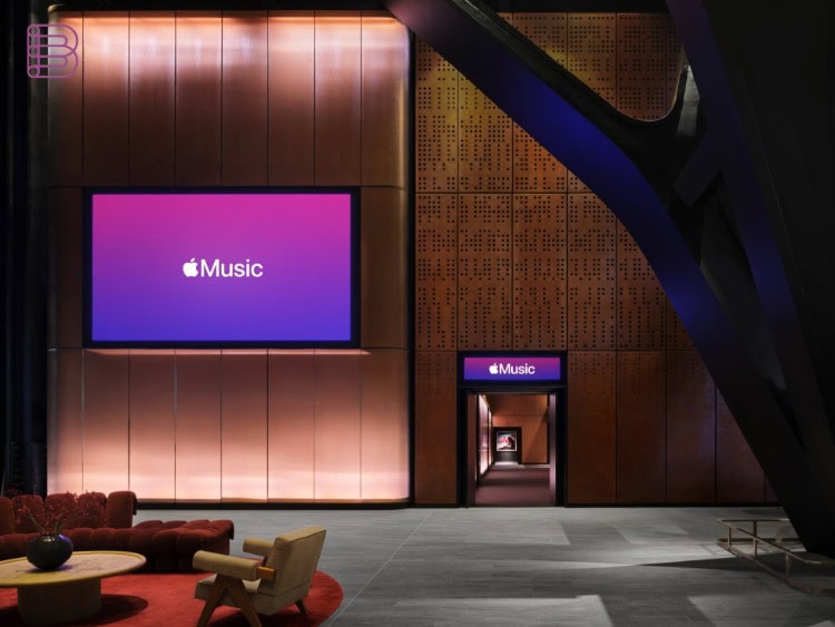 Foyer of Apple Music Hall with seating area and large screen