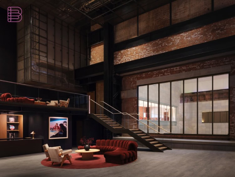 Foyer of Apple Music Hall with glass window and staircase overlooking the River Thames