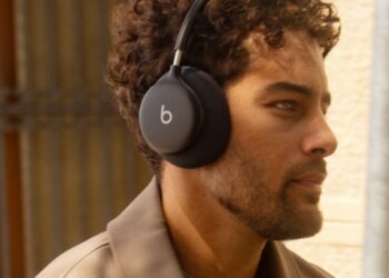 Person wearing Beats 360 over-ear headphones outdoors