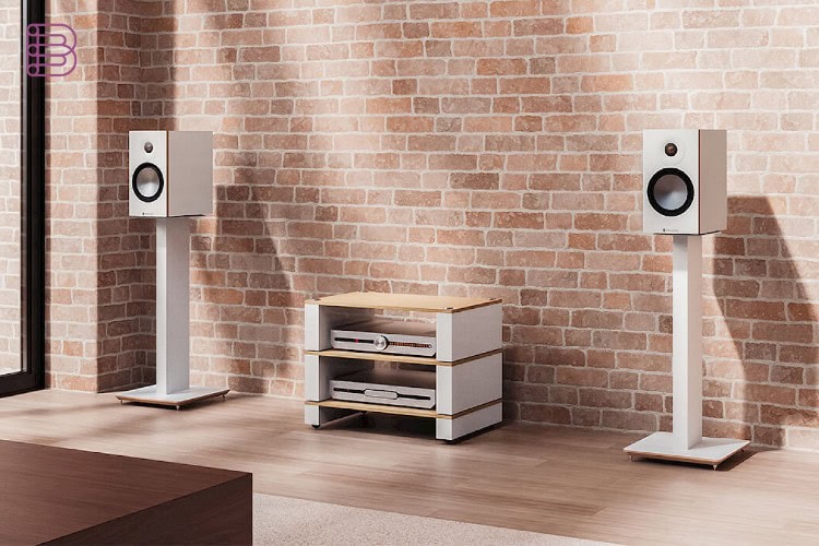 White Blok Axis speaker stands supporting loudspeakers against a brick wall