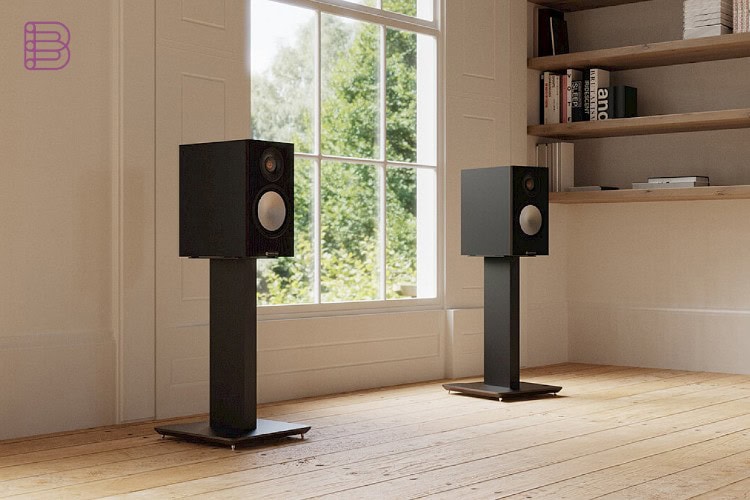 Black Blok Axis speaker stands supporting loudspeakers by a window