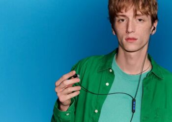 Bose Noise Cancelling Wired Earbuds worn by a model with the inline remote visible
