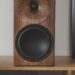Buchardt E50-S standmount loudspeaker in rounded smoked oak on a living room shelf
