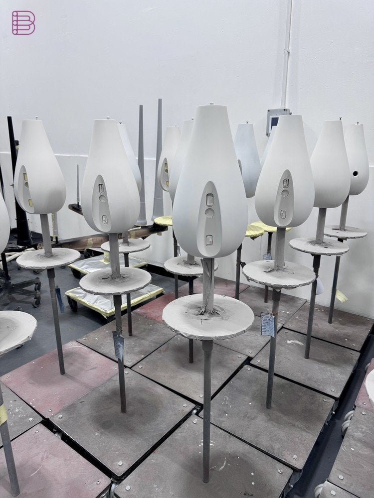 Worker spray-painting a Bowers & Wilkins cabinet in the Worthing paint booth