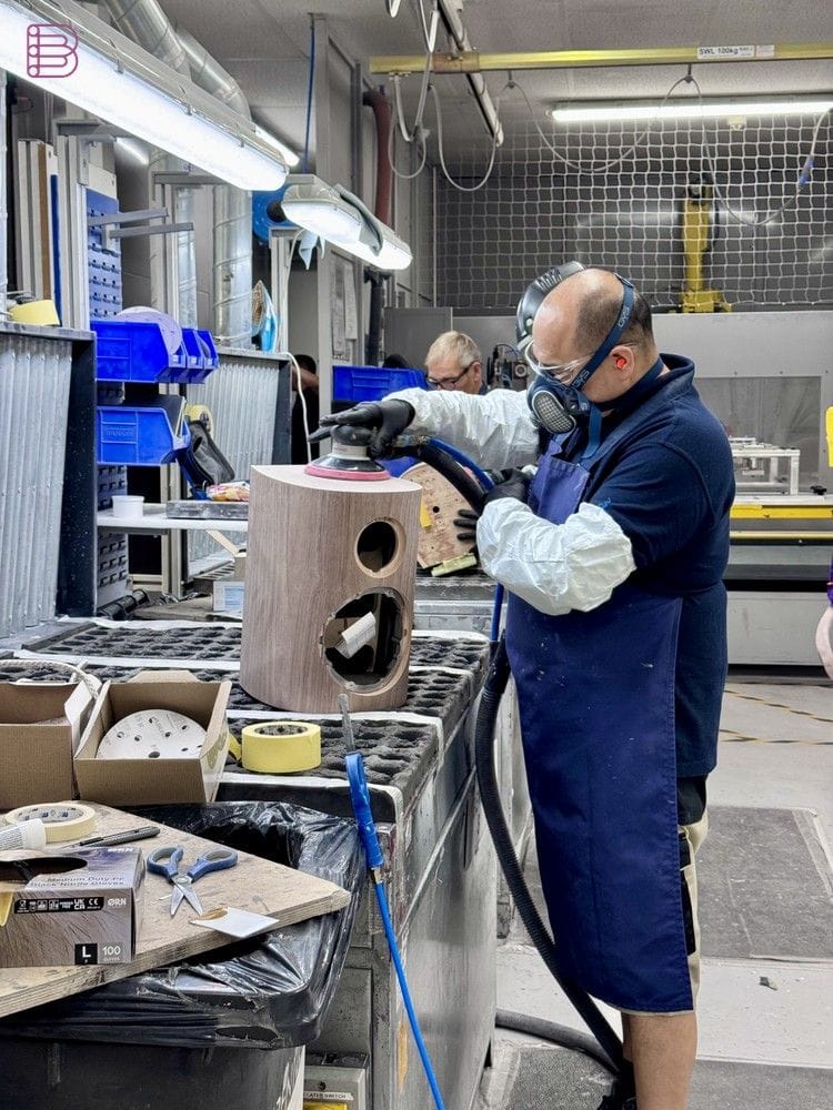 Worker sanding a Bowers & Wilkins loudspeaker cabinet at the Worthing factory
