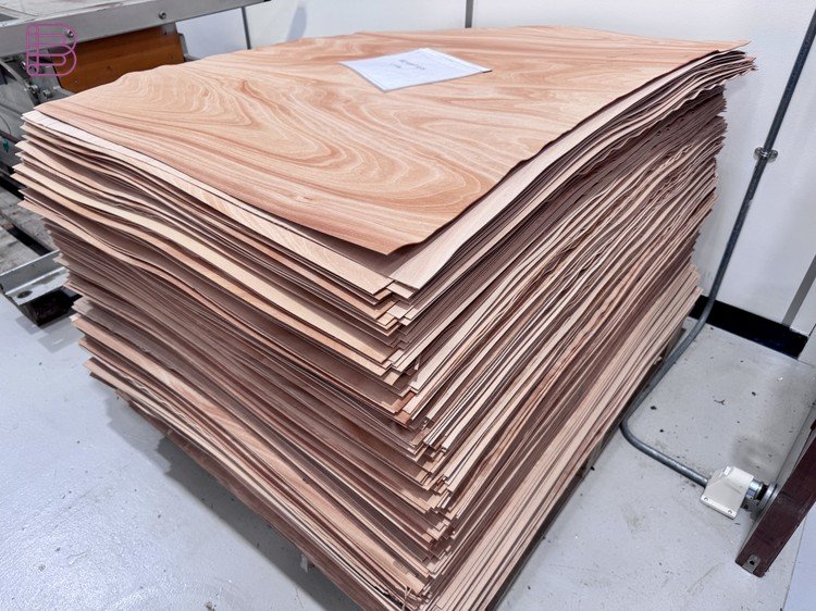 Stack of raw wood veneer sheets at the Bowers & Wilkins Worthing factory