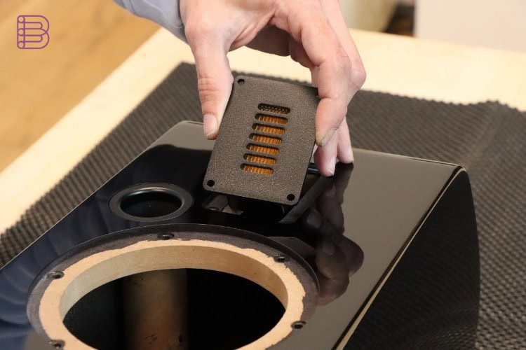 Esprit Audio technician installing the pleated AMT tweeter membrane into a Stella cabinet during hand assembly