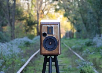 Esprit Audio Stella walnut bookshelf speaker on a stand outdoors