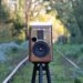 Esprit Audio Stella walnut bookshelf speaker on a stand outdoors