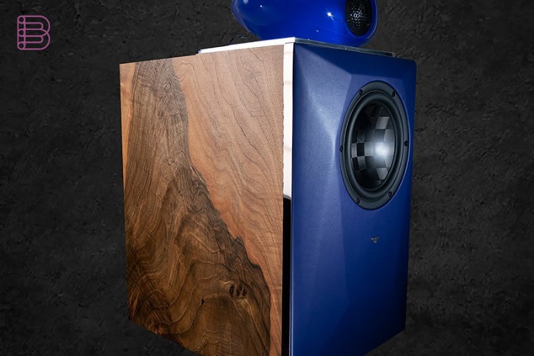 Falcon Bravo The Dome loudspeaker three-quarter view with walnut cabinet and blue illuminated dome tweeter