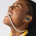 Fresh 'n Rebel Twins Elite 2 true wireless earbud worn in-ear during a colourful lifestyle shoot