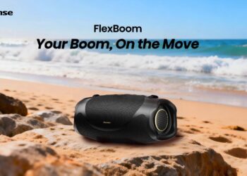 Hisense FlexBoom portable Bluetooth speaker on a rock at the beach