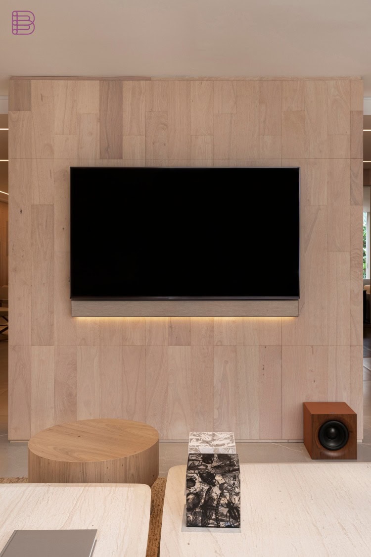 Magna Audio Brutalist concrete subwoofer installed under a living room TV wall