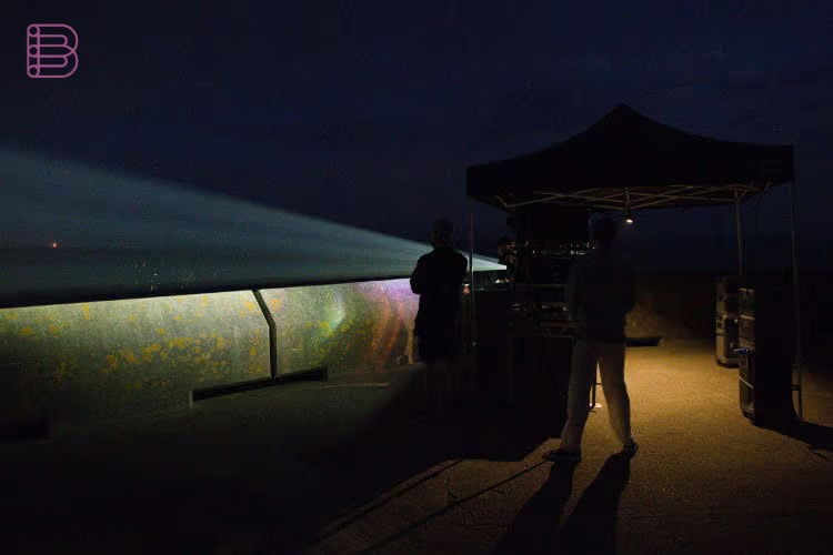 Pixel Sharp crew watching the Panasonic PT-RQ35K2 projection beam illuminate the White Cliffs of Dover at night