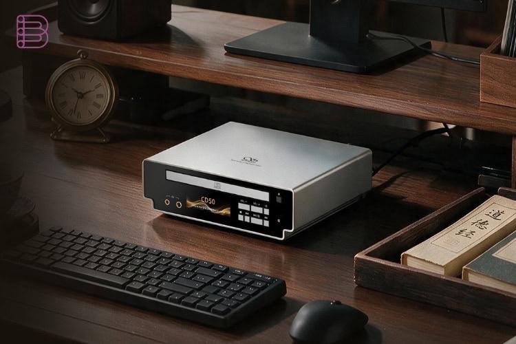 Shanling CD50 on a desk with clock and monitor in a home office setup