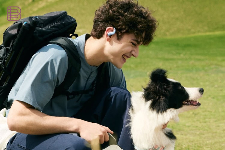 Shokz OpenFit Air 2 worn outdoors during a hike with a dog