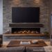 Sonance SBXL-100 soundbar mounted beneath a large TV above a stone fireplace