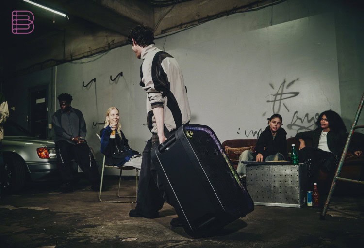 Sony ULT TOWER 7 party speaker being wheeled to a gathering, showing its portable design