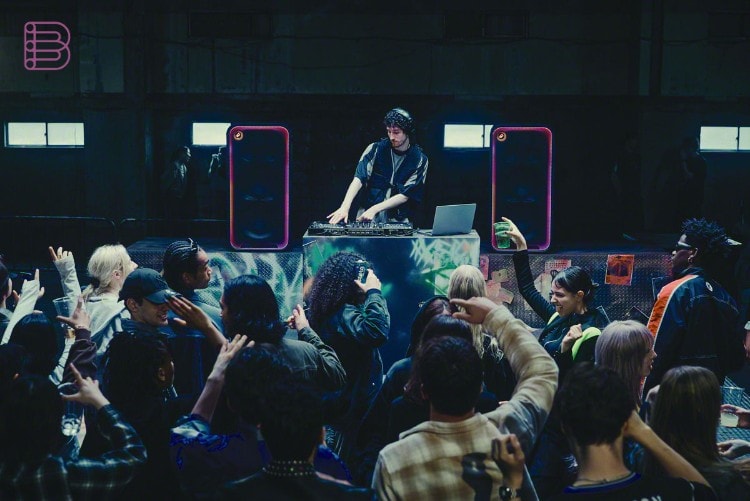 A DJ using two Sony ULT TOWER MAX speakers at a warehouse party