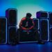 Sony ULT TOWER MAX, 7 and 5 party speakers with a model in a colourful lit party setting