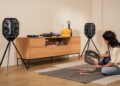 Teufel IKONIO wireless speakers on tripod stands in a living room