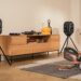 Teufel IKONIO wireless speakers on tripod stands in a living room