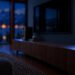 Arendal 1610 Black Edition bookshelf speakers in a living room at night