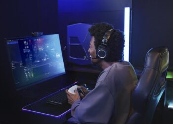 Gamer wearing the Audio-Technica ATH-M50xSTS-WL at a PC setup