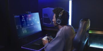 Gamer wearing the Audio-Technica ATH-M50xSTS-WL at a PC setup