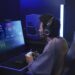 Gamer wearing the Audio-Technica ATH-M50xSTS-WL at a PC setup