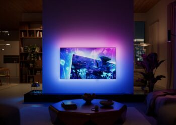 Philips OLED+951 Ambilight TV glowing in a darkened living room