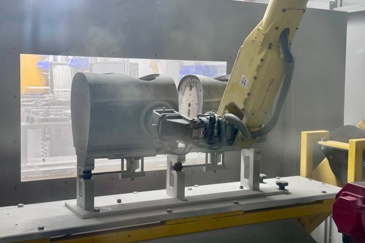 Robot arm sanding a loudspeaker cabinet