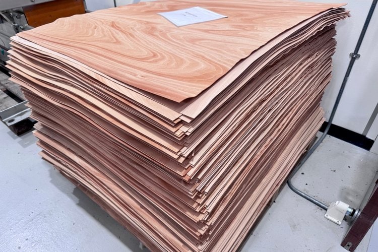 Stack of wood veneer sheets at the Bowers & Wilkins factory