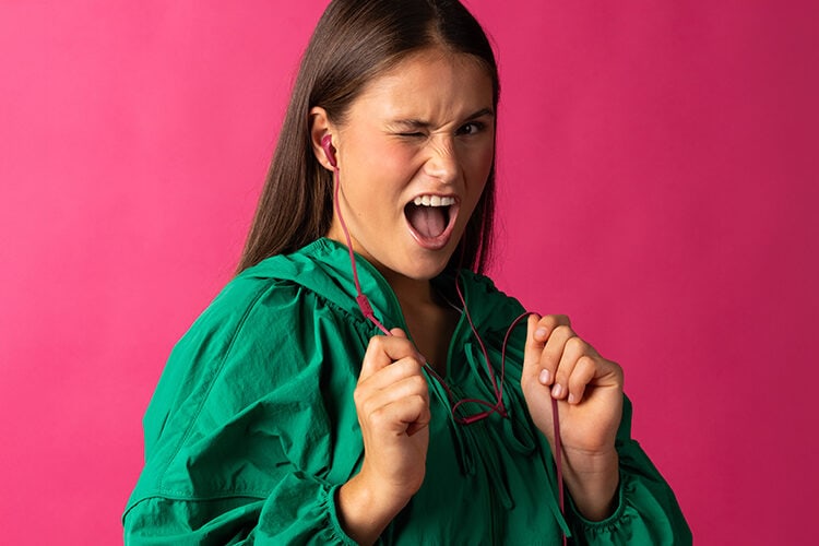 Fresh 'n Rebel Flow 2 wired earbuds worn by a model