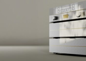 Goldmund Mimesis Statement preamplifier stack in silver with gold accents, two knobs and a display, against a soft taupe backdrop