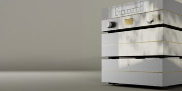 Goldmund Mimesis Statement preamplifier stack in silver with gold accents, two knobs and a display, against a soft taupe backdrop
