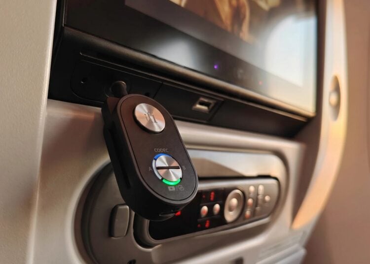 iFi UP Travel Max Bluetooth transceiver plugged into an airplane seat screen