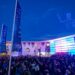 ISE 2027 venue at twilight with a drone light show and crowd gathered outside