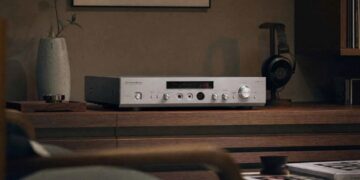 Luxman P-800u headphone amplifier on a wooden sideboard with headphones