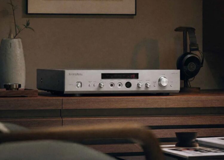 Luxman P-800u headphone amplifier on a wooden sideboard with headphones
