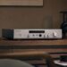 Luxman P-800u headphone amplifier on a wooden sideboard with headphones