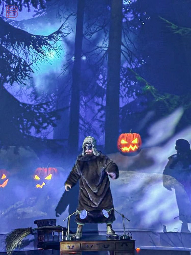 Portrait shot of Halloween-themed projected scene with costumed figure inside immersive dome