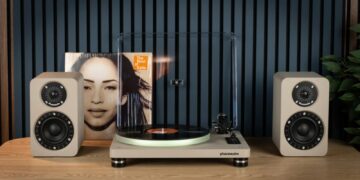 Phaze Audio Tilia Active bookshelf speakers in latte finish next to a turntable