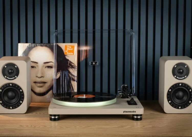 Phaze Audio Tilia Active bookshelf speakers in latte finish next to a turntable