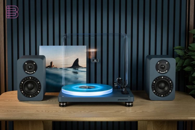 Phaze Audio Tilia Active bookshelf speakers in ocean blue finish next to a turntable
