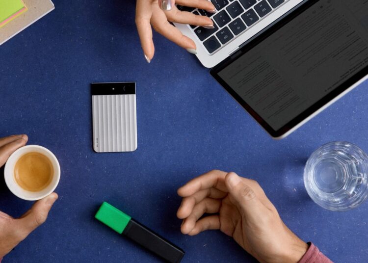 Plaud Note Pro AI voice recorder on a desk next to a laptop