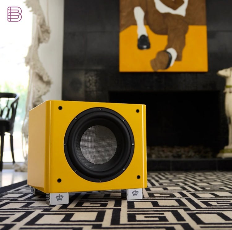 REL T/9x SE subwoofer in yellow finish, shown in a living room